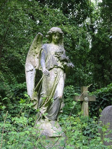 A statue of an angel stands atop a grave in Highgate Cemetery, London. Grave Statues, Highgate Cemetery London, Cemetery Angels, Highgate Cemetery, Cemetery Statues, Painting References, Angel Statue, Ancient Statues, Angel Sculpture