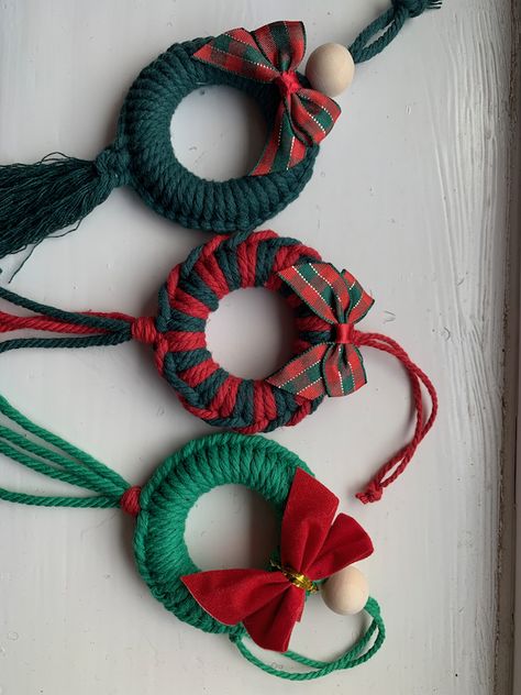 Beautiful Macrame Christmas Wreath Tree Decorations.  These are carefully made using high quality cotton cords and a wooden ring/bead.  Each wreath can be made in a variety of colour combinations, simply choose your design number (photo 2) and your desired colour from the drop down menus at the checkout :)I am always happy to make in any colour so just drop me a message if this is your preference e.g. red and white.The completed decoration measures approximately 6cm in diameter with the tassels/ Macrame Christmas Presents, Beads Christmas Decorations, Curtain Ring Christmas Decorations, Macrame For Christmas, Macrame Christmas Decor, Crochet Xmas Decorations, Bead Christmas Decorations, Wooden Bead Wreath, Macrame Christmas Decorations