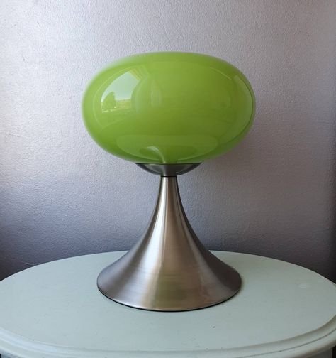 Design mushroom table lamp/night light with touch control. Made in the '80s. Designed by Prisma Leuchten. The lamp has a stainless steel base with a super nice green glass cap above it. The hood has a nice shape. When you touch the foot, the lamp turns on. 3 positions has the lamp, after 4 taps the lamp is off again. Diameter hood 24 cm Height 29.5 cm Diameter foot 19 cm Weird Lamps, 80s Lamp, 80s Furniture, Funky Lamps, Retro Mushroom, Mushroom Table Lamp, Retro Table Lamps, Mushroom Table, Dream Furniture