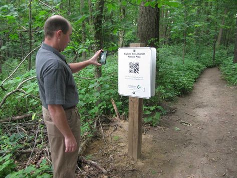 [...] it was with some skepticism that I learned the Nature Conservancy would be adding a walking audio guide to the Lisha Kill Natural Area in Niskayuna. The guide lets people with smart phones listen to recorded informational segments about the preserve as they walk the trails. People with smart phones and a QR code app can scan the codes to see the Nature Conservancy web site and the audio files – one for each sign. Troy Weldy, director of ecological management for the New York Chapter of Nature Trail Design, Nature Trail Signs, Trail Signs, Nature Education, Trail Design, Natural Nursery, Guide Sign, Brochure Holders, Outdoor Park