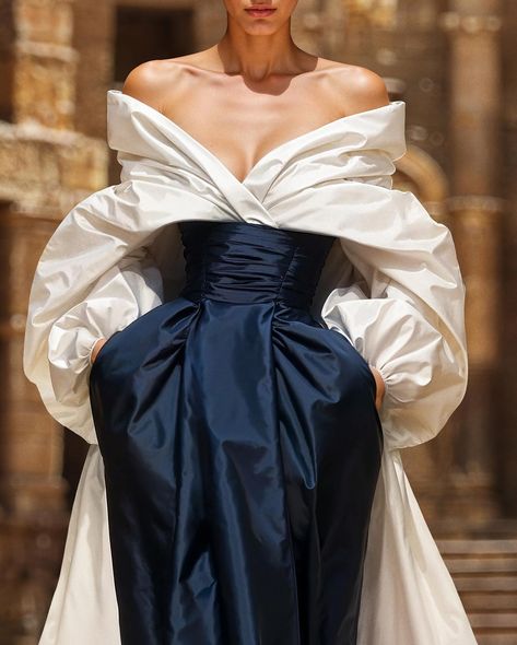 Unveiling the couture taffeta moulage dress, a voluminous off-white gown with an off-shoulder top,a pleated bodice, and a striking blue opal skirt with pockets. Smoothed off with a taffeta over-skirt train for a regal, elegant silhouette. #saiidkobeisy #hautecouture #FW2425 Moulage Dress, Saiid Kobeisy, 2020 Wedding Dresses, Old Fashion Dresses, Pleated Bodice, White Gowns, Skirt With Pockets, Haute Couture Fashion, Fashion Costume