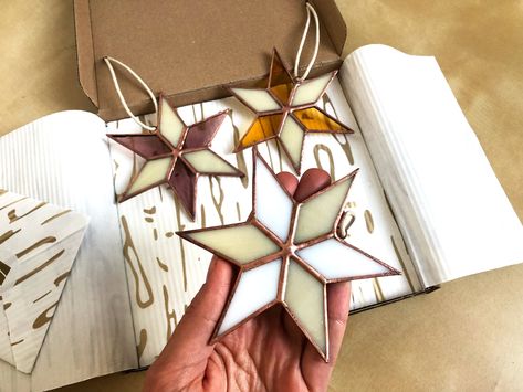 Gift Box of three upcycled stained glass Christmas ornaments! These eco-friendly recycled glass stars can be a lovely suncatcher or part of your Holiday decoration. You might also like https://www.etsy.com/shop/DasimaStudio?ref=seller-platform-mcnav§ion_id=33017073 These stars are made in copper foil stained glass and wire, with vintage finishing details. Stands 11 cm tall /4.3 inch/. The set is gift packed and is ready to placed under the tree! Lovely and unique gift, even just for yourself! - Stained Glass Christmas Ornaments, Star Suncatcher, L'art Du Vitrail, Handmade Holiday Gifts, Ornament Exchange, Stained Glass Ornaments, Stained Glass Decor, Glass Making, Stained Glass Christmas