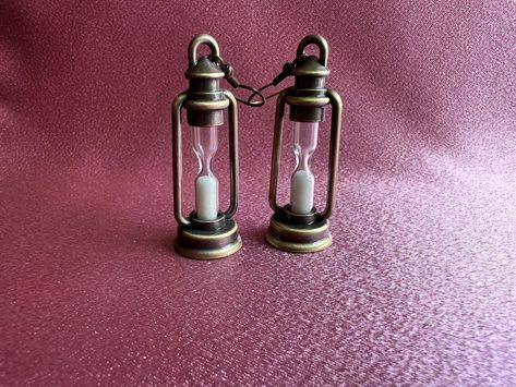 Hourglass lantern earrings https://etsy.me/3q5XttJ new jewelry in stock at #CosmicCreatedMagic the #etsyjewelry #etsyshop #whitesand #hourglass #lanterns #newearrings #adventureawaits #sandglass #bigearrings #campinglife #etsyfinds #newjewelry #uniquegifts #summertime Hourglass Jewelry, Lantern Jewelry, Hourglass Earrings, Spell Jar Earrings, Hourglass Diffused Light, Ancient Egypt Fashion, Lantern Earrings, Hourglass Sand Timer, Egypt Fashion