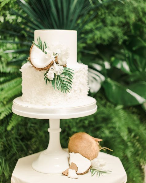 There are so many tropical details to incorporate onto your big-day dessert, but we think coconuts are an appropriate (and delicious) addition. Beverly's Bakery added shards of the fruit onto this all-white confection, along with florals and greenery from Inessa Nichols Design. For a cohesive touch, Detailed Touch Events included coconuts on the table below. Simple Wedding Cake Tropical, Tropical Simple Wedding, Simple Summer Wedding Cake, Simple Tropical Wedding Cake, Simple Hawaii Wedding, Wedding Cake With Tropical Flowers, Simple Beach Wedding Cake, Island Wedding Theme, Beach Wedding Cakes Simple