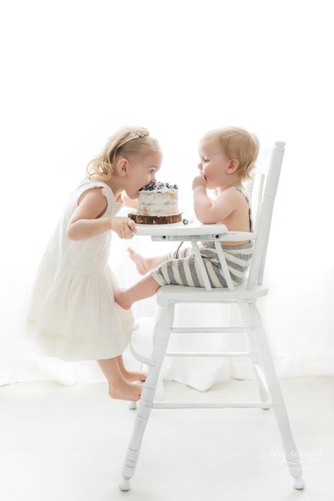 Baby in high chair cake smash with big sister taking a bite image by Reaj Roberts Photography, Phoenix baby photographer. Simple first birthday photos, cake smash photos, cake smash in highchair, cake smash with siblings, indoor sibling photos. Simple First Birthday, First Birthday Milestone, Cake Smash Pictures, Indoor Birthday, Milestone Photography, Birthday Highchair, First Birthday Pictures, Birthday Milestone, Lifestyle Photography Family