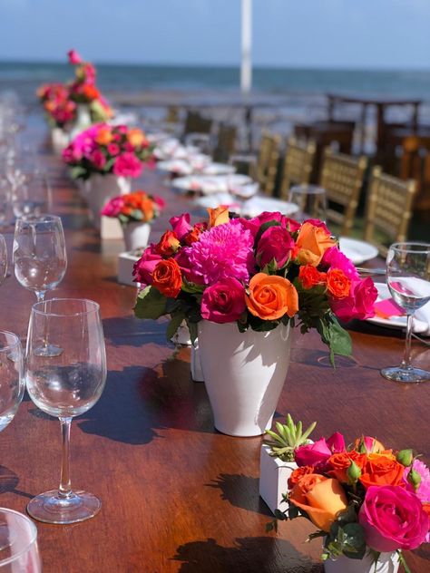 Hot Pink Orange Centerpieces, Bright Table Decorations, Pink And Orange Floral Centerpieces, Hot Pink Mexican Party, Pink And Orange Flower Centerpieces, Mexican Theme Flower Centerpieces, Bridal Shower Hot Pink And Orange, Colorful Centerpieces For Party, Cantarito Centerpiece Flowers