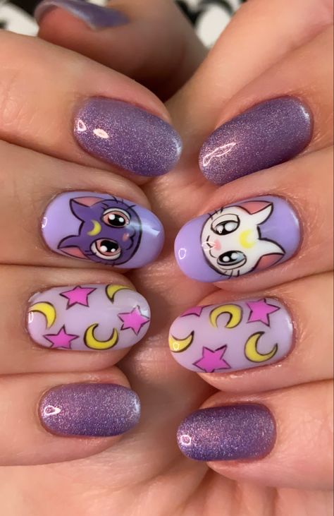 Artemis and Luna on the middle finger nails, Usagi’s blanket and purple with glitter for the others. By Why Not Nails Sailor Moon Purple Aesthetic, Sailor Moon Nails Design, Steven Universe Nails, Sailor Moon Inspired Nails, Cute Cartoon Nails, Cartoon Art Nails, Uñas Sailor Moon, Sailor Moon Nail Art, Artemis And Luna