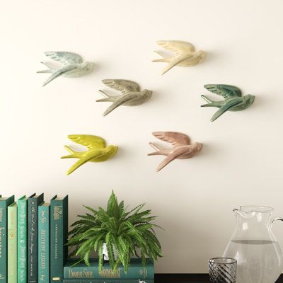 Showcasing a set of six ceramic swallows in an array of hues, this colorful flock transforms your walls into an artful focal point. | Winston Porter 6 Piece Swallows Wall Decor Set Ceramic in Green/Pink/Yellow, Size 6.0 H x 5.0 W x 2.0 D in | Wayfair | Home Decor Gallery Wall Objects, Ceramic Wall Decor, Farmhouse Landscaping, Botanical Wall Decor, Nature Wall Decor, Geometric Wall Decor, Bird Wall Decor, Island Decor, Accent Wall Decor