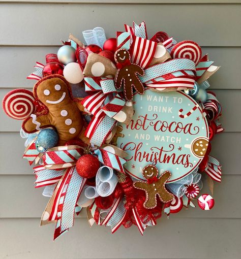 You can truly begin to smell the gingerbread with this adorable and whimsical wreath. Cute gingerbread wreath is such a fun loving decor piece to add your holiday decorations. Gingy will truly greet your guests with an adorable Merry Christmas this season.  Marcy's wreaths also make a beautiful and unexpected gift so give the gift of chic style this season. Marcy's Wreaths take pride in producing unique and beautiful designs for your front doors and home interior designs.  CARE - Upon receipt, cut the cable ties from the bottom of the box and carefully remove the wreath from the box. - Wipe clean with damp cloth as needed. - Keep out of direct sunlight. - To store wreath, recommend lightly wrapping it in tissue paper and storing flat in the box in which it arrived or a box of comparable si Whimsical Christmas Wreath Diy, Gingerbread Cabinet Decor, Gingerbread Living Room Decor, Pastel Christmas Wreath, Gingerbread Wreaths Christmas, Christmas Tree Goals, Coffee Wreath, Christmas Theme Decor, Candy Wreaths