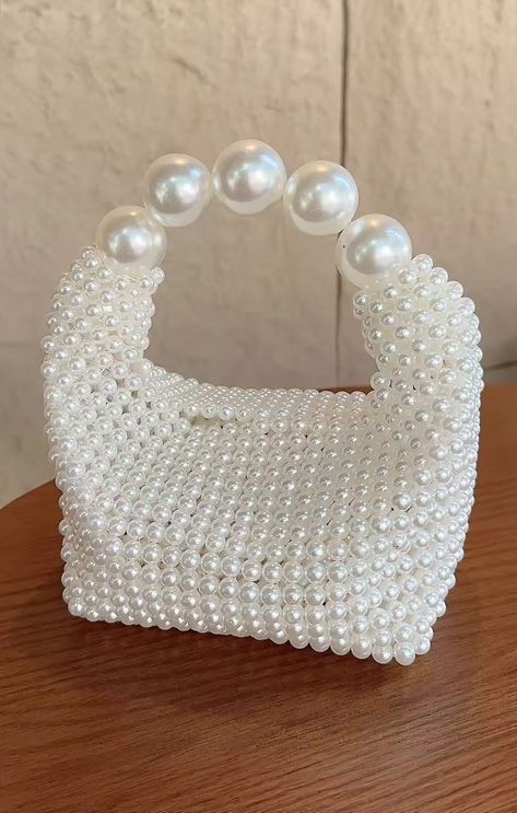 Add a touch of bridal charm to your look with the Penelope Bag! This cute little purse is adorned with shimmering pearls, adding a touch of sophistication to any outfit. Make every moment memorable with this chic accessory by your side! Pearl Bag Design, Bead Bags Designs, Pearl Bags Purses, Beaded Purses Pattern, Pearls Purse, Pearl Beaded Bag, Pleasure Principle, Pearl Bags, Pearl Purse