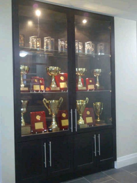 Our Trophy Showcase at the office Amazon Cabinet, Trophy Display Shelves, Trophy Cabinets, Trophy Display Case, Shoe Storage Design, Wall Display Case, Modern Tv Room, Glass Cupboard, Cabinet Glass Doors