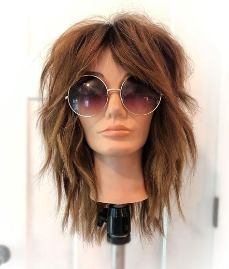 Mannequin head with a gorgeous modern shag haircut. Discover the top 10 haircuts that make you look younger and refresh your look in no time! Say hello to a more vibrant, youthful version of yourself with these trendy styles. Get ready to embrace a fresher, more youthful appearance today! Mom Shag Haircut, Midlife Hairstyles Over 40, Long Bob Shag Hairstyles, Overgrown Shag Haircut, Medium Shag Without Bangs, Womens Medium Shag Haircuts, Mid Shaggy Haircuts, Wavy Shag With Bangs Medium Layered, Brown Shag Haircut With Highlights