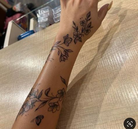 Tattoos With Deep Meaning For Black Women, Hand Tattoos Wrap Around, Tiger Lily Vine Tattoo, Arm Sleeve With Small Tattoos, Cute Outline Tattoos For Women, Floral Wrap Around Tattoo Forearm Color, Hibiscus Flower Back Tattoos, Unique Flower Tattoos For Women, Thigh Tats For Women Meaningful