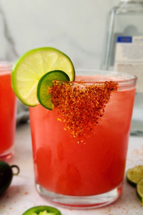 Close-up picture of a watermelon margarita with a tajin rim Cocktails With Tajin, Tajin Rim Margarita, Margarita With Tajin Rim, Tajin Recipes Drink, Tajin Rimmed Drinks, Drinks With Tajin Rim, Tajin Cocktails, Watermelon Tajin, Tajin Watermelon