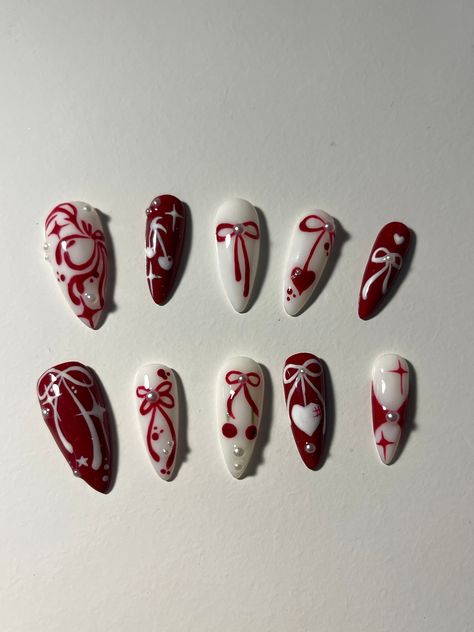 --> Nail shape + length: medium stiletto 🌸 ** if you want a different shape, make sure to include it in the personalization section 🎀All orders ship with a file, nail glue, cuticle pusher and stickers :D 🎀If you need custom sizes make sure to include it in the personalization section!! **there might be slight differences in the nail art as they are a handmade product** IG: @stxrnails Red Nails Alternative, Read Nails Design, Sultry Red Nails, Chinese Halloween Nails, Red Detailed Nails, Valentines Day Nails Designs Red, Y2k Nails Christmas, Red White Nails Acrylic, Dark Colored Acrylic Nails