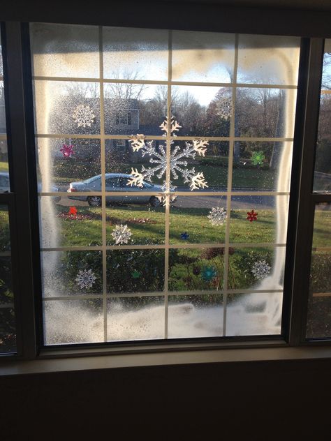 Christmas window art. Spray snow and cling ons Fake Snow On Windows, Snow On Windows Spray Ideas, Winter Office Decorations, Fake Snow Window Ideas, Window Snow Spray, Christmas Window Art, Christmas Grotto Ideas, Holiday Wine Bottle Crafts, Spray Snow