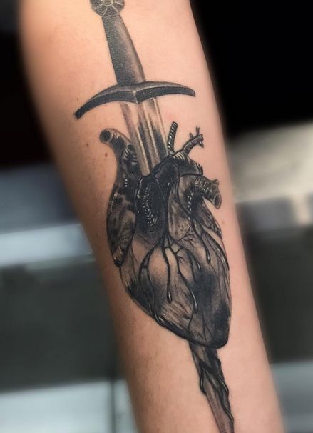 Heart and Knife tattoo by artist Em Becker #tattoo #tattooart #tattooartist #inkart #art #bodyart #tattoos #tattooinspiration #tattooideas #heart #hearttattoo Heart On My Sleeve Tattoo Men, Dager And Heart Tattoo, Knife Going Through Heart Tattoo, Crushed Heart Tattoo, Heart Break Tattoos Men, Knife In Heart Tattoo, Dagger In Heart Tattoo, Heart Tattoos Men, Heart With Knife Tattoo