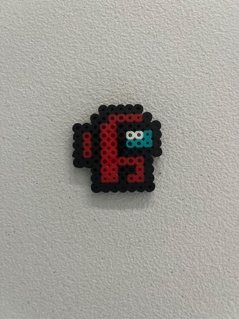 This is a small Among Us design made of Perler beads with a keychain! Customizable colors! Dungeons And Dragons Perler Beads, Perler Bead Patterns Among Us, Hama Beads Small Patterns, Peeler Bead Design, Iron Bead Art, Cross Perler Beads, Small Perler Ideas, Hama Beads Patterns Small, Hammer Beads Ideas