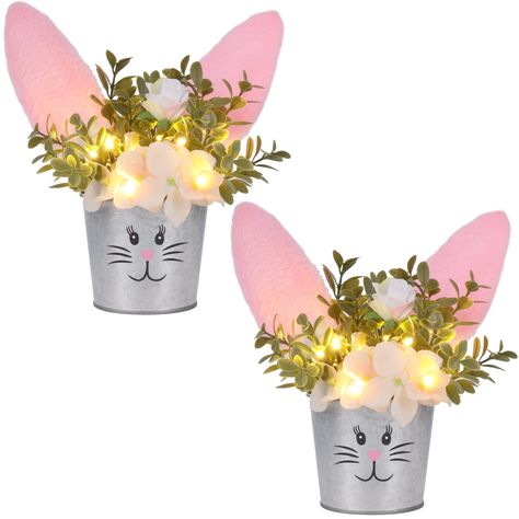 PRICES MAY VARY. Easter Table Decor: Our bunny artificial flower tabletop centerpiece is a nice addition to your Easter home decor. The plant pot is designed as a rabbit with plush bunny ears on the top, looks adorable and distinctive. Realistic Flowers: The flowers and leaves are lifelike and realistic, display the artificial flower in your home will make you feel closer to nature or Spring, it will add a perfect touch to your parties. LED Lights: There are several LED lights among the flowers, Diy Ostern, Little Christmas Trees, Easter Bunny Decorations, Decorations For Home, Spring Party, Easter Table Decorations, Bunny Plush, Bunny Ears, Easter Table