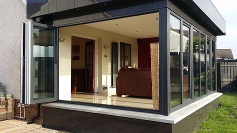 Great Britain-based Budget Conservatories—while adding a certain sophistication to their word for sunroom—call this modern addition a Contemporary Sunroom, Sunroom Extension, Modern Sunroom, Sunroom Kits, Small Sunroom, Accordion Doors, Fold Door, Alternative Living, Sunroom Furniture