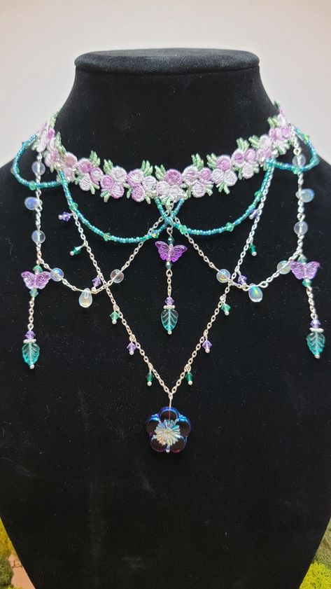 The fairy choker of your dreams! This delicately embroidered choker is adorned with small gold-plated or silver-plated chains and beautiful glass and crystal beads. Two color ways are available with matching set of dainty butterfly earrings: pink and green or purple and teal. The choker is 15 inches long with a two inch extender. If you would like it longer, I will be happy to add length. Please specify your desired measurements in the personalization section. The center drop is six inches long. All metal is nickel-free.