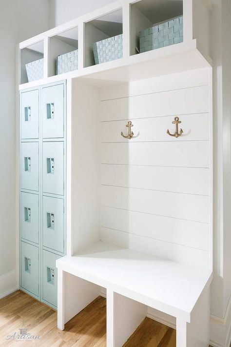 White cottage mudroom stands out with Tiffany blue accents and features four rows of stacked Tiffany blue lockers positioned under overhead shelves holding Tiffany blue baskets above a white built in bench fixed against a shiplap trim accented with brass anchor hooks. Pool Entryway Ideas, Pool House Storage, Casa Garage, Armoire Entree, Apartment Things, Laundry Room/mud Room, Mudroom Entryway, Mudroom Design, Cape House