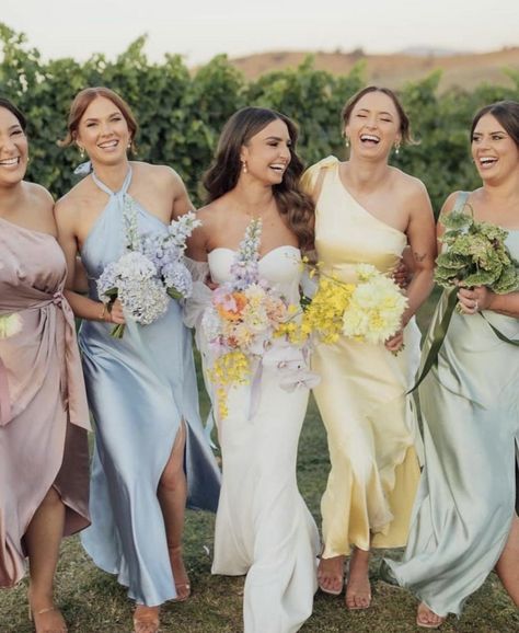 @loverly on Instagram Vogue Wedding Guest Outfit, Summer Garden Bridesmaid Dresses, Wildflower Bridesmaids Dresses, Colorful Wedding Party Attire, Pastel Wedding Guest Outfit, Spring Bridesmaid Dresses Mismatched, Pastel Wedding Guest Dress, Bridesmaid Lineup, Multi Colored Bridesmaid Dresses