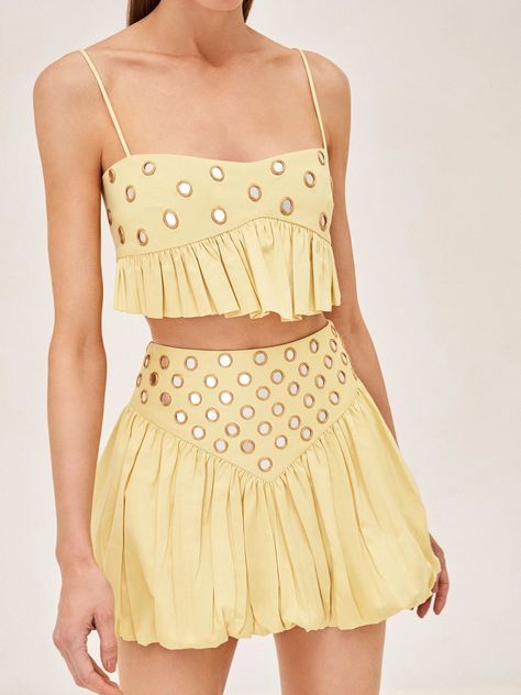 Featuring a soft yellow hue, intricate ruffled hem, and glimmering mirrored details, the Liane Top offers a captivating charm. Whether paired with the Zinn Skirt for a coordinated look or dressed down with high-waisted denim, this top effortlessly adds a touch of casual elegance to any outfit. Colorful Two Piece Set, Study Abroad Clothes, Cute Tops For Country Concert, Multi Layer Skirt, Maxi Skirt Sets, Love Island Fashion, Daily Drills Outfit, Summer Soiree Outfit, Euro Summer Fashion