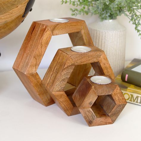 This Set of 3 Hexagonal Tea Light Holders brings warmth and charm to any space. Crafted from natural mango wood, these wooden block hexagons nest together beautifully, creating a versatile display. The set includes three tea light holders, each with a unique and natural finish, along with three tealights. Perfect for adding a cosy ambiance to your home, these holders combine rustic appeal with functional design. Wooden Block Hexagons Set Of 3 Nesting Natural Mango Wooden Finish Tea Light Holder 3x Tealights Included Large Dimensions W20cm x H18cm x D5cm Medium Dimensions W15cm x H13cm x D5cm Small Dimensions W10cm x H10.5cm x D5cm Colour Light Brown Wood Material Mango Wood Wood Tea Light Holder, Wooden Tea Light Holder, Shop Projects, Tea Light Holders, Wood Shop Projects, Wooden Candle Holders, Wood Crafts Diy, Wood Candles, Refurbished Furniture