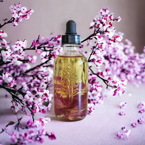 Give your skin a glowing boost of hydration this summer with our Cherry Blossom scented rose-infused botanical body oil. Each 4 fl oz glass bottle contains a blend of luxurious organic oils and beautifully infused with stems of dried rose petals. Our blend of nutrient-rich oils replenish the skin with essential minerals and creates a barrier to lock in moisture for soft, radiant skin. These oils can also be applied to hair to reduce frizz and increase shine! Cherry Blossom is a classic fresh and airy scent with notes of blooming cherry blossoms infused with magnolia and rose, hints of cherry, tonka bean, and sandalwood. Ingredients: *Apricot Kernel Oil, *Sweet Almond Oil, *Avocado Fruit Oil, *Jojoba Oil, Squalane (Olive), *Macadamia Nut Oil, *Argan Oil, *Kukui Nut Oil, *Rosehip Oil, *Red R Cherry Blossom Scent, Luxury Oil, Avocado Fruit, Essential Minerals, Kukui Nut, Macadamia Nut Oil, Raspberry Seeds, Glass Dropper Bottles, Organic Oils