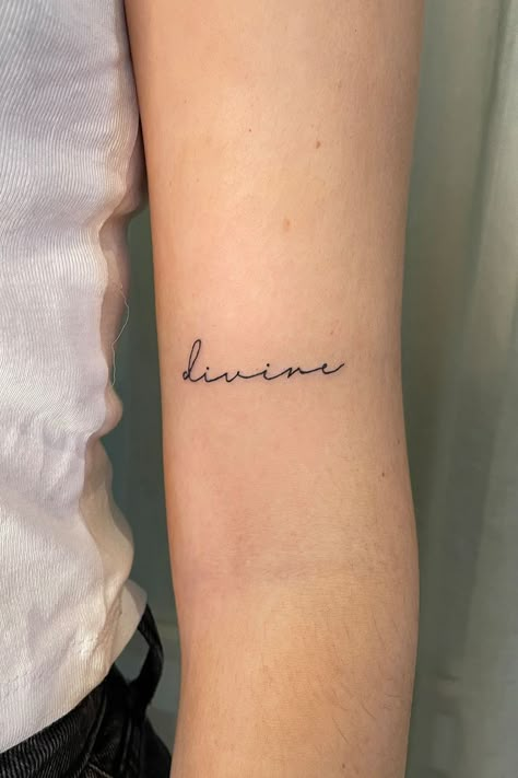 Delicate Cursive Tattoo, Precious Word Tattoo, Divina Tattoo Word, Spaced Out Cursive Font Tattoo, Divine In Cursive Tattoo, Dainty Written Tattoos, Abundance Tattoo Ideas, Divine In Cursive, Name Tattoo Aesthetic