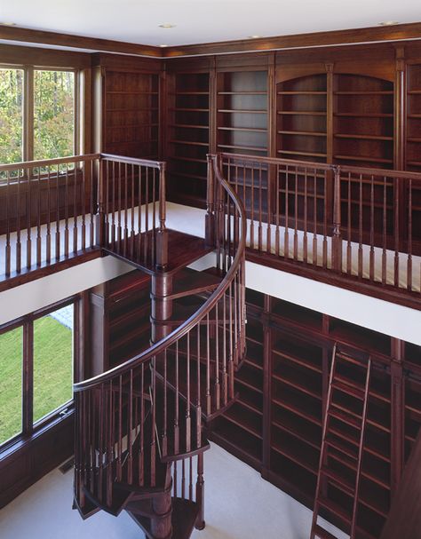 For book lovers, here is upper view of a chestnut colored custom-built library that can make your book collection even more sophisticated with the overall display . #customhomes #library #librarydesign #wood 2 Story Office Library, Interior Design Library Home, Home Library Large, Two Floor Library, Library With Mezzanine, Big House Library, Custom Home Library, Massive Home Library, Old House Library