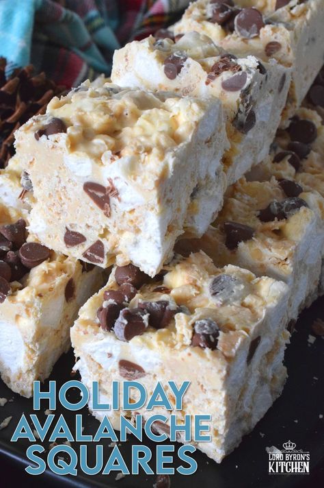 These no-bake treats are prepared with lots of white chocolate, creamy peanut butter, a few cups of rice cereal, and a good helping of marshmallows too. Holiday Avalanche Squares are absolutely delicious! The white chocolate is melted together with the peanut butter, and once cooled, the other ingredients are folded in to create these wonderfully high and cloudy-soft squares! #squares #bars #nobake #christmas #holiday #baking #cookies #chocolate Holiday Avalanche Squares, White Chocolate Squares, Christmas Baking With Marshmallows, No Bake Squares And Bars Recipes, Christmas Square Recipes, White Chocolate Christmas Treats, Xmas Squares Recipes, Christmas Treats With Marshmallows, Christmas Squares And Bars Holidays