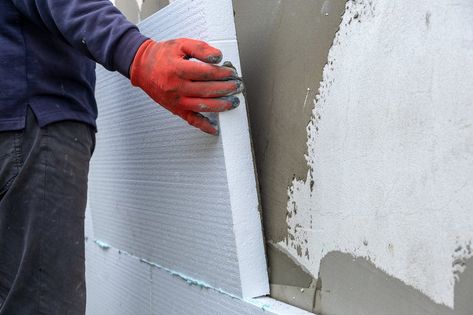 Construction worker installing styrofoam insulation sheets on house facade wall for thermal protection. Thermal Insulation Wall, Foam Board Insulation, Styrofoam Insulation, Foam Insulation Board, Installing Insulation, Insulation Sheets, Insulation Board, House Facade, Foam Panels