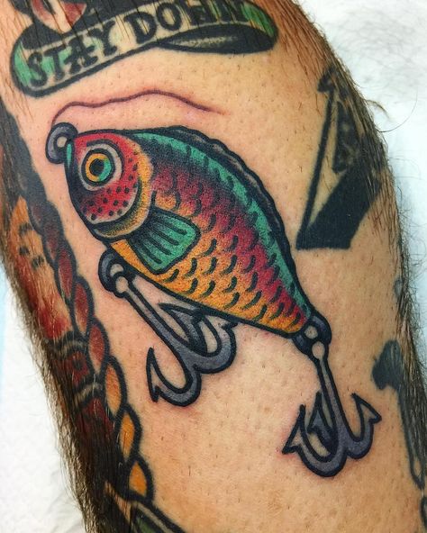 Fishing lure tattoo - traditional tattoo American Traditional Fishing Lure Tattoo, Funny Neo Traditional Tattoo, Traditional Fishing Lure Tattoo, Fishing Traditional Tattoo, Old School Fishing Tattoo, Fishing Bobber Tattoo, American Traditional Cross Tattoo, Colored Traditional Tattoo, Cut Here Tattoos