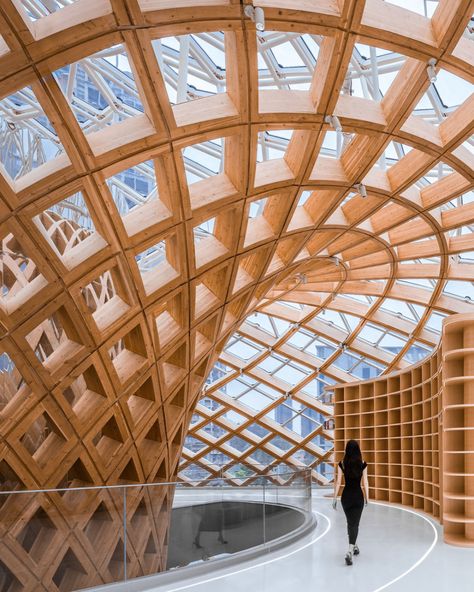 “The Exhibition Center is located at the central landscape plaza of the CANNANO Park. It is a dome-like structure with a diameter of about 39m and a height of 21m. It is composed of two independent systems: a spherical glulam latticed shell structure and a main steel structure.The spherical glulam latticed shell made of glulam originates from the concept of the ‘sequoia tree.’ Rising from the center of the site, it spreads outward as it nears the top of the glass curtain wall, forming an ‘app... Typology Architecture, Landscape Plaza, Building Modern, Lattice Structure, Tree Structure, Shell Structure, Sequoia Tree, Glass Curtain Wall, Glass Curtain