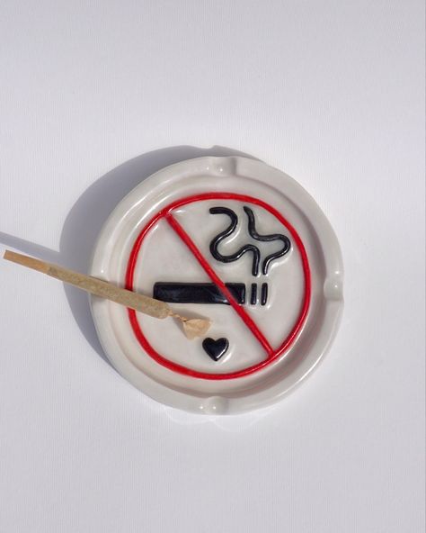 no smoking sign quirky ceramic ash tray, hand built, hand made and  hand painted in the UK. The ideal ashtray to complete your bad girl/ 420 stoner girl aesthetic. Also the perfect handmade gift for any stoner bestie. Find this functional art piece and more on sicalimited.com Functional Hand Built Pottery, Midnight Gospel Ashtray, Ceramic Art Ash Tray, Pottery Painting Ash Tray, Stone Clay Art, Clay Ashtray For Boyfriend, Ceramic Boyfriend Gifts, Y2k Ashtray, Cute Ash Tray Clay