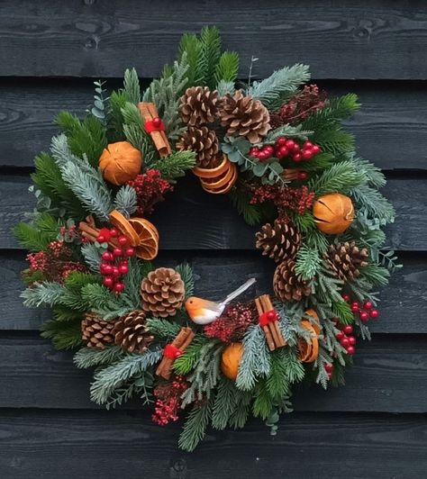 Artificial Christmas Wreath Classis and Traditional  The complete wreath sits on a 30cm natural Vine Base The Wreath is arranged with Contrasting Colours of Christmas Spruce and Eucalyptus. Fresh dried Oranges, Cinnamon and Fir Cones are added to give that Christmas Smell.  Red Berries and a little Robin complete this Beautiful Christmas Wreath. This Wreath is best under a cover area outside to keep the Fruit fresh and then pop it in a plastic bag until next year and the beautiful scent will ret Fresh Christmas Wreath Ideas, Classy Christmas Wreaths, Christmas Wreaths Natural, Dried Fruit Wreath, Dried Orange Christmas Decorations, Xmas Wreaths Ideas, Fruit Wreaths, Natural Christmas Wreaths, Traditional Christmas Wreath