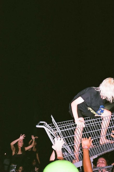 black background, crowd underneath a girl riding a shopping cart 90s After Party, Punk Show Photography, House Show Aesthetic Punk, Punk Party Aesthetic, Moshpit Photography, Punk Concert Aesthetic, Punk Playlist Covers, Punk Show Aesthetic, Punk Asethic