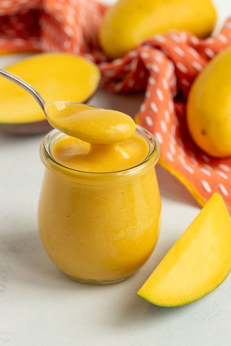 Mango curd in a pint jar with a spoonful of curd hovering over the top of the jar.  Fresh mangos are in the background Mango Curd Recipe, Mango Gelee, Toast Yogurt, Mango Curd, Milk Curd, Jam Recipes Homemade, Mango Sauce, Pie Filling Recipes, Curd Recipe