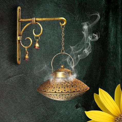 PRICES MAY VARY. Handcrafted hanging incense burner: This incense burner is made of high-quality Brass and has a beautiful antique design with hand-carved details. It is perfect for yoga meditation, spiritual practice, or as a vintage home decor piece. Spiritual Atmosphere: Create a serene ambiance for spiritual practices like Reiki, yoga, and meditation as the incense gently wafts from this hanging censer, elevating your mindfulness sessions. Functional Design: This incense holder doubles as a Indian Vintage Home Decor, Vintage Brass Decor, Brass Wall Hanging, Ethnic Home Decor, Family Wall Decor, Pooja Room, Metal Wall Hangings, T Lights, Meditation Space