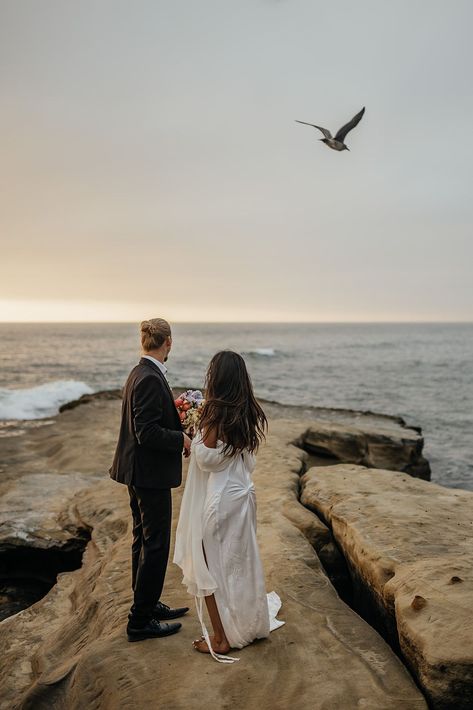 Bride and groom looking out at the ocean during their cliffside elopement in San Diego. See more Southern California elopement locations, Southern California elopement ideas, and Southern California elopement photos! Book Kim for your destination wedding photography or California elopement photography at kimkayephotography.com! Sunset Cliffs San Diego Elopement, Sunset Cliffs Elopement, Elopement Activities, Sunset Cliffs Wedding, Oregon Spring, California Elopement Locations, Cliffside Elopement, Cliffside Wedding, Sunset Cliffs San Diego