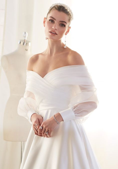 This bolero is a stunning accessory to add a touch of sophistication to the wedding day look. Nora features blouson sleeves with delicate satin cuffs, creating an alluring balance between contemporary and classic styles. ● Organza ● Blouson sleeves ● Satin cuffs ● Pleated bodice ● Off the shoulder neckline ● Available in UK sizes 6-28 ● Perfect for a modern wedding! Please contact your nearest stockist for pricing and availability. Organza Bolero, Ellis Bridal, Sincerity Bridal, Wedding Bolero, Casablanca Bridal, Bolero Wedding, Bridal Wedding Dress, Wedding Dresses Satin, Bridal Dress Design