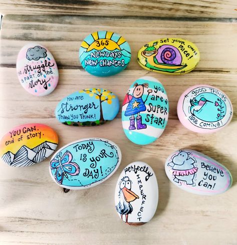 "Artsy, folksy, happy hand-painted rocks. Perfect to give to your family, friends, neighbors, clients or students...anyone who could use some encouragement and a reminder that you care.  All rocks are handmade from eco-friendly cement for smoothness and durability, and are hand-painted with acrylics by me. Sealed with high quality resin for maximum shine and to keep them safe from the elements--they last beautifully whether kept outside or in a sunny windowsill.  These rocks are all between 2-3 inches long by 1.5-2 inches across. Because they are individually hand-painted, they may differ slightly from the picture.  Please specify in the \"Number of Items\" Box how many items you would like to purchase.  You may order up to ten items. EASELS COUNT AS ONE ITEM. For example, if you want 3 ro Kindness Rocks Ideas, Inspirational Painted Rocks, Decorated Rocks, Aesthetic Paint, Bible Verse Painting, Sunshine Flowers, Rock Games, Stone Paint, Hand Painted Bible