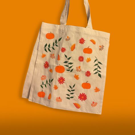 Embrace eco-conscious style with our hand-painted Fall Things Tote Bag! Featuring all the things you love about autumn, this reusable, eco-friendly bag is both a work of art and a sustainable choice for everyday use. Make a statement and reduce your environmental footprint with every outing. Tote Bag Info: *100% Organic Cotton *Standard Size (15"W x 16"H) with 21" Handles *Reinforced at stress points for extra durability!  *Design made using a mix of acrylic and fabric mediums *Care instructions will be included to ensure a long lasting product! *Colors may vary slightly from picture CARE INSTRUCTIONS: Cleaning of 100% cotton bags by washing machine is not recommended as washing shrinkage may occur. Hand wash is recommended. Hang dry is necessary before high- temperature ironing. **DO NOT Halloween Tote Bags Diy Paint, Fall Tote Bag Painting Ideas, Canvas Bag Painting, Tote Bags Painting, Canvas Tote Bag Design, Paint Tote Bag, Autumn Tote Bag, Painted Tote Bag, Spooky Basket