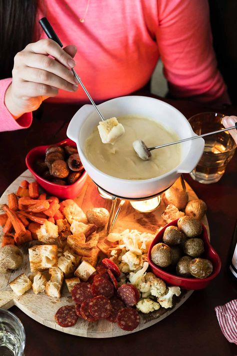 Cheese Fondue for Two: a classic cheese fondue recipe, scaled to the perfect portion to share with your sweetie for a fun & romantic date night at home! 3types of cheese slowly melt into a garlicky white wine sauce, creating an irresistibly rich & creamy fondue. Pair with your favorite dippers – roasted vegetables, sausage, bread, salami, & more! – this homemade fondue is an easy-yet-special recipe for Valentine's Day or your next cozy date night in! #fonduerecipes #fondueideas #datenightideas Valentines Fondue Dinner, Special Meals For Two, Valentines Fondue Board, Fondue Dinner For Two, New Years Fondue, Valentine’s Day Fondue, Cheese Fondue Board, At Home Fondue Night, Romantic Night In