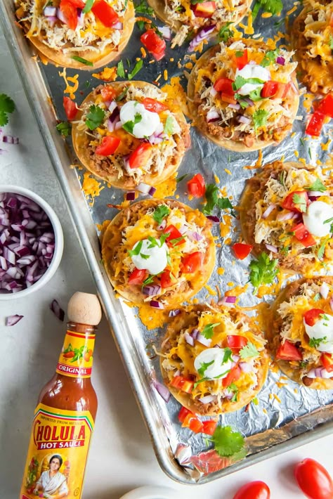 Bake a sheet pan full of these mini chicken tostadas in about 30 minutes for an easy dinner or fun party snack. Crispy baked street taco tortillas are loaded with beans, chicken, cheese and your favorite toppings. Mini Chicken Sheet Pan Tostadas, Mini Sheet Pan Chicken Tostadas, Mini Sheet Pan Tostadas, Sheet Pan Tostadas, Easy Nachos Recipe Beef, Street Taco Tortillas, Tostadas Recipes, Gumbo Recipe Crockpot, Taco Pinwheels