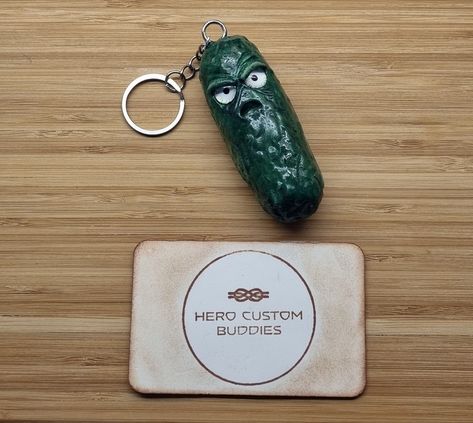 Meet the Not So Positive Pickle, a quirky and comically grumpy addition to your keychain collection! Handcrafted from high-quality polymer clay, this keychain features a sour-faced pickle that's sure to bring a smile (or a smirk) to your face.#keyring #keychains #positivity #supportsmallbusiness #clayart #pickle #grumpypickle #grumpy Pickle Keychain, Steampunk Robots, Lanyard Bracelet, Keychain Collection, Clay Keychain, Poly Clay, Beaded Lanyards, Paracord Bracelets, Functional Accessories