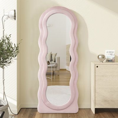 The Full Length Mirror is a beautiful and unique addition to any room. The irregular full body mirror and wave design make it stand out from other mirrors. This mirror is not only elegant and visually appealing but also highly practical and durable. It serves as a versatile accessory for daily use, making it a perfect addition to your space. Finish: Pink | Winston Porter Nak Full Length Mirror in Pink, Size 63.0 H x 24.0 W x 1.0 D in | Wayfair | Home Decor Pink Squiggle Mirror, Wavy Pink Mirror, Pink Full Body Mirror, Cute Wall Mirror, Preppy Mirrors, Cute Mirrors For Bedroom, Preppy Mirror, Blush Pink Bedroom Decor, Pink Dorm Room Decor