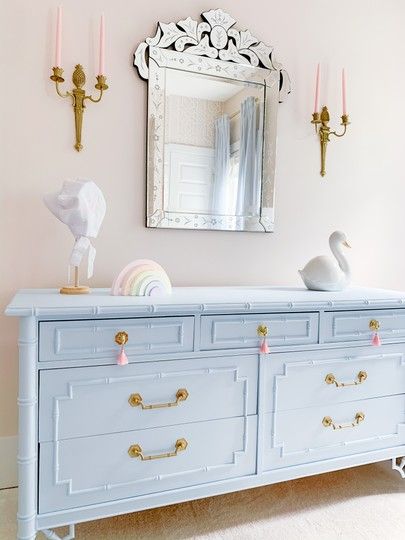 our nursery design was based around this vintage bamboo dresser that we repainted in the perfect blue to accent the pink walls... perfect combo for a baby girl.  We are so obsessed with the vintage gold pineapple sconces... Bedrooms Vintage, Blue Nursery Girl, Baby Blue Bedrooms, Faux Bamboo Dresser, Blue Girls Rooms, Girls Blue Bedroom, Bamboo Dresser, Blue Bedrooms, Venetian Wall Mirror